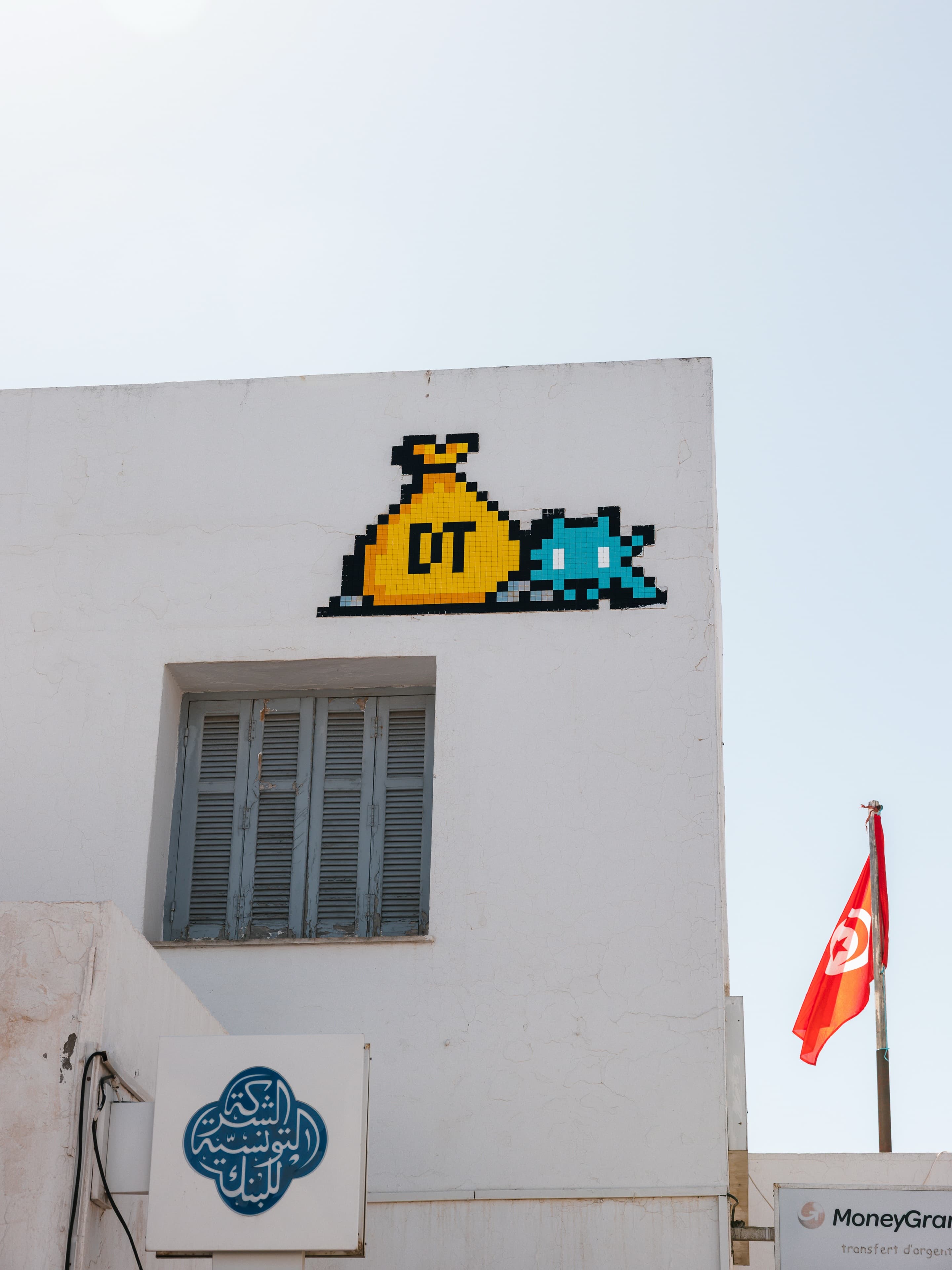 Photo by Alexander Lotus in Djerba. May be pop art of buildings and text.